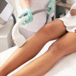 Close up of the medical worker conducting laser hair removal with a vacuum suction