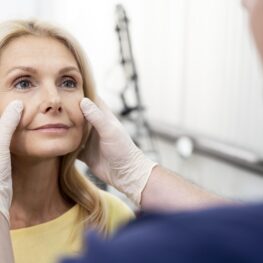 doctor examining a woman's face